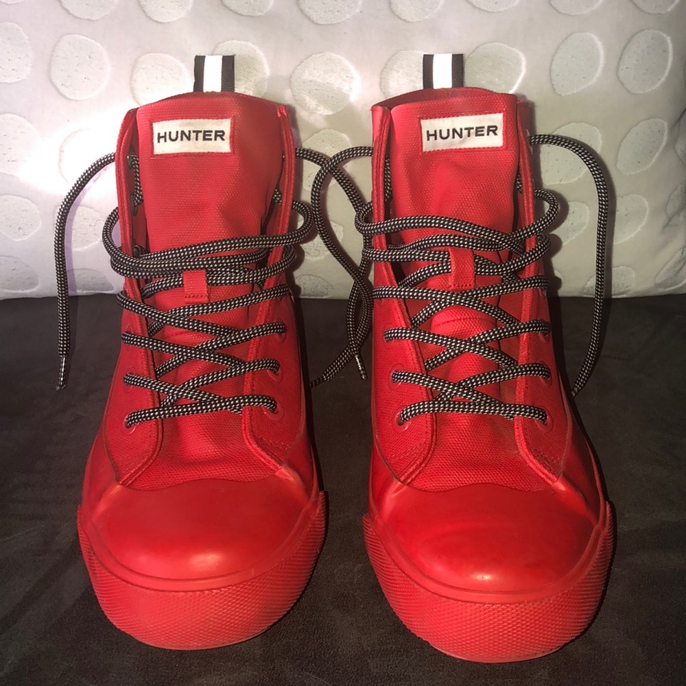 Fire engine red lace up rubber and canvas boots.